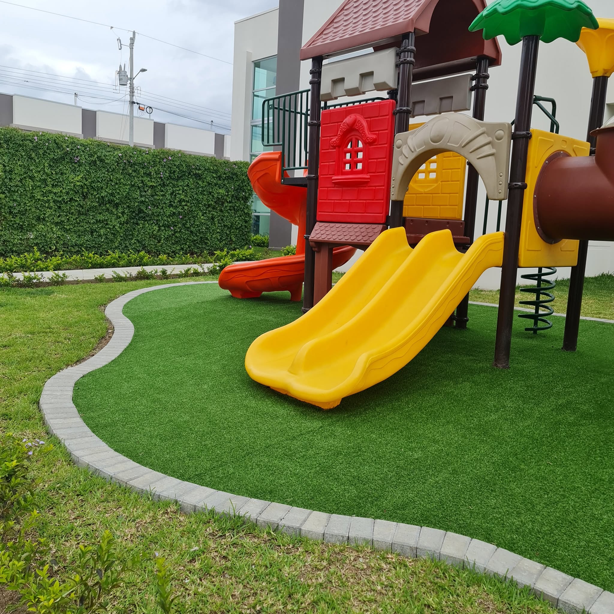 Zona de juegos infantiles con superficie sintética